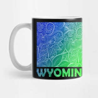 Colorful mandala art map of Wyoming with text in blue and green Mug